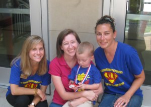 After CHAMP Camp graduation. From left to right: Our awesome clinician, Me, the kiddo proudly checking out his medal, and Jodi Kumar.